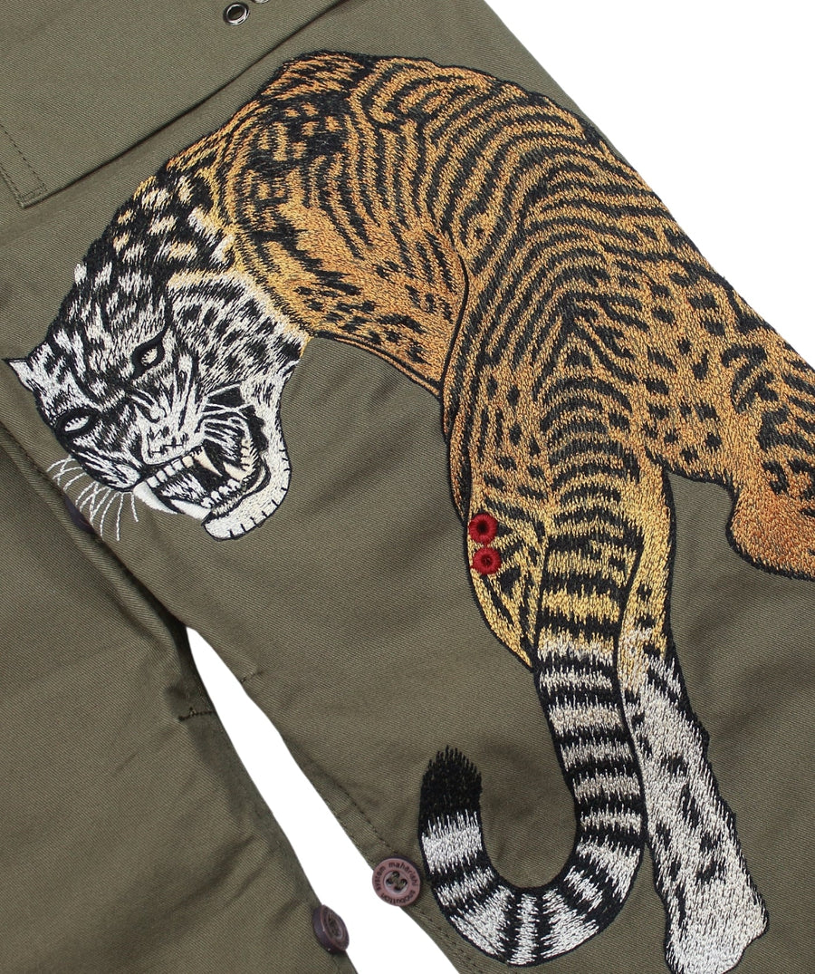 The Maharishi Kid's Tiger Snopants 5508 feature bold tiger embroidery, adjustable waistband, and durable fabric—perfect for stylish, everyday adventure.