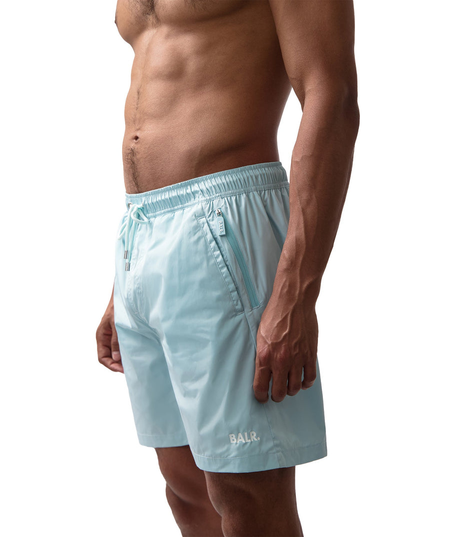 BALR Logo Swim Shorts B1451.1035 – premium swim shorts featuring an elasticated waistband with a drawcord, bold BALR branding, and two zippered pockets. Designed for comfort and style, these shorts are perfect for beach days or poolside relaxation.