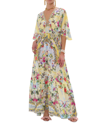 CAMILLA Flor Fantástica Long Dress 00033221 – A luxurious long dress adorned with the bold Flor Fantástica print, detailed embellishments, and a flowing silhouette.