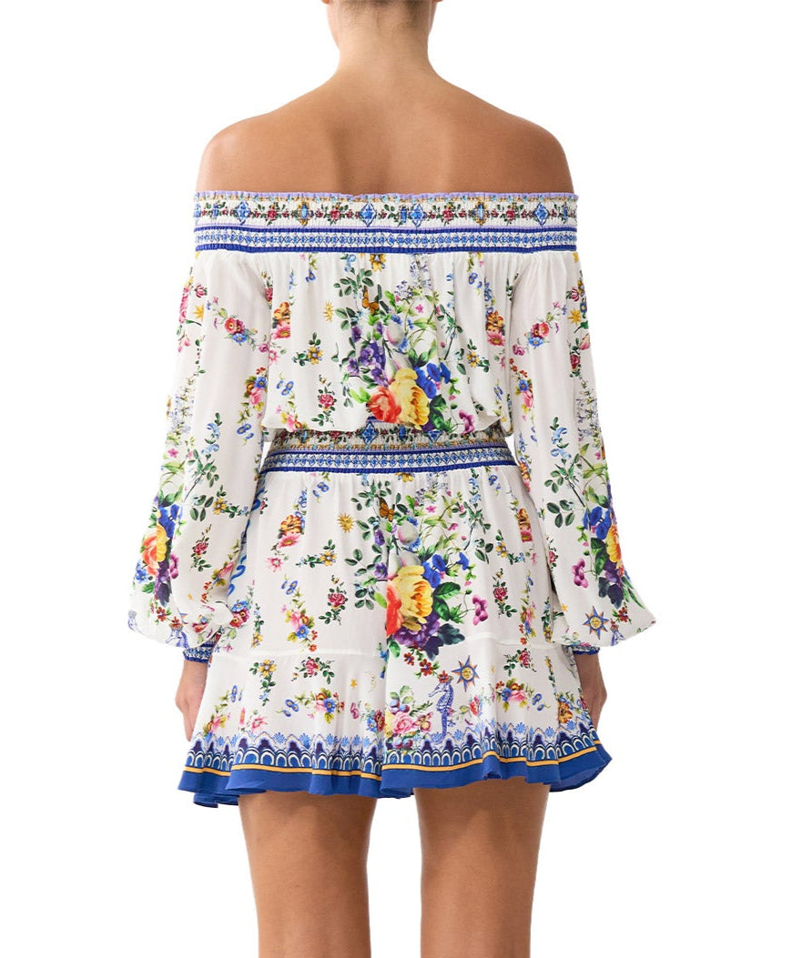Chic and playful, the CAMILLA Tiles Darls Off Shoulder Short Dress 00035220 features bold prints and flirty ruffles—perfect for sunny days and summer nights.