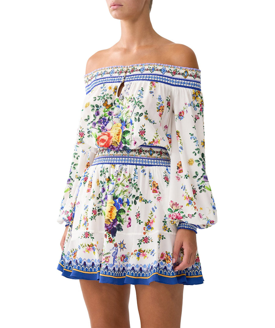 Chic and playful, the CAMILLA Tiles Darls Off Shoulder Short Dress 00035220 features bold prints and flirty ruffles—perfect for sunny days and summer nights.
