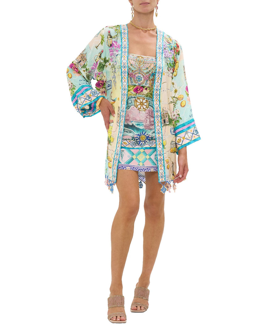 Embrace coastal charm in the CAMILLA Just Coasting Short Kimono Wrap 00035638, featuring oceanic prints, luxe silk, and a relaxed fit for effortless style.