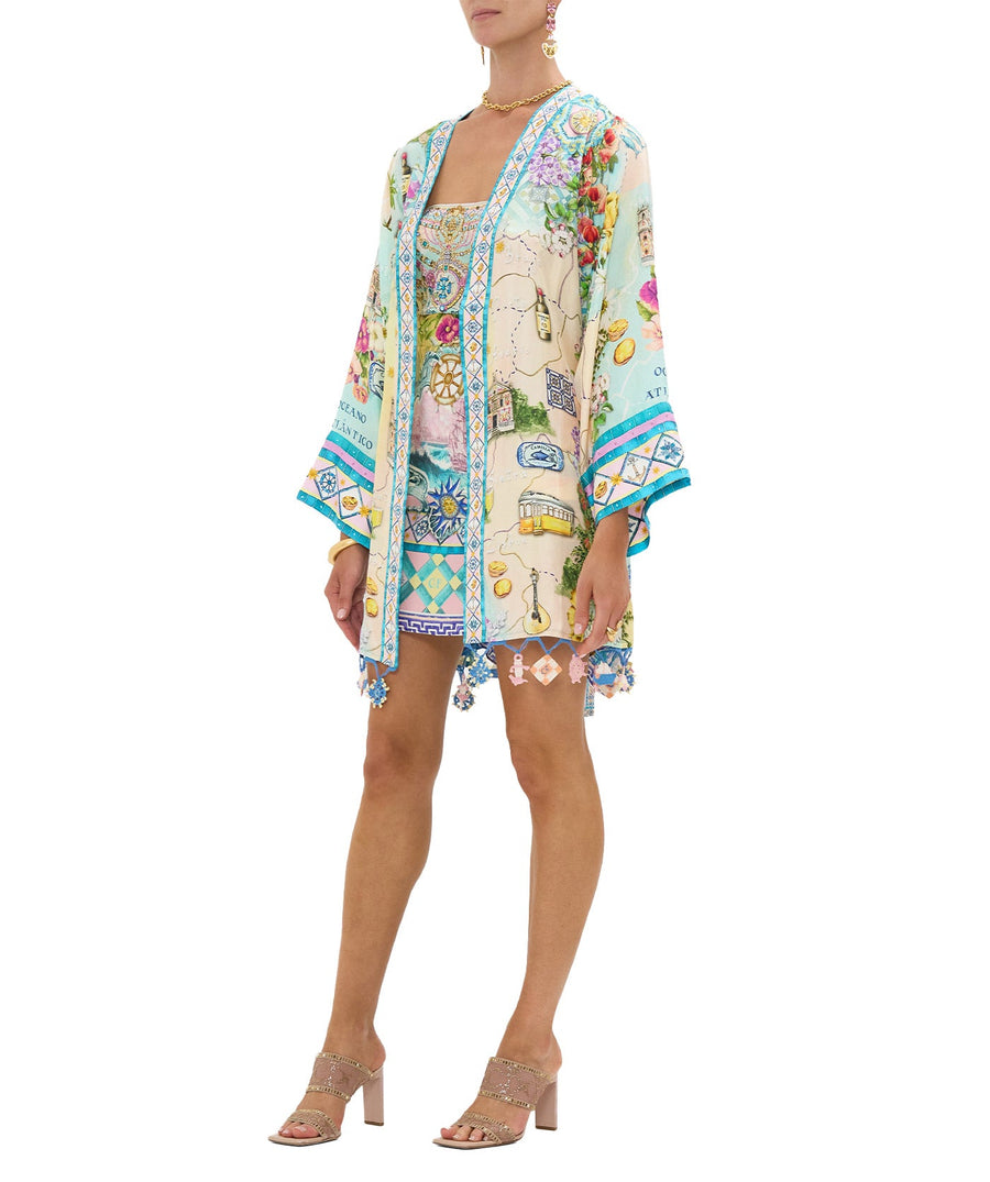 Embrace coastal charm in the CAMILLA Just Coasting Short Kimono Wrap 00035638, featuring oceanic prints, luxe silk, and a relaxed fit for effortless style.
