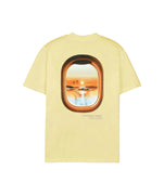 A t-shirt with a graphic of an airplane window view on a light yellow background